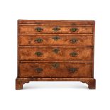 A BURR WALNUT AND FEATHERBANDED CHEST OF DRAWERS IN THE MANNER OF GILES GRENDEY