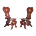 Y AN UNUSUAL PAIR OF GEORGE II MAHOGANY, SATINWOOD AND LINE INLAID HALL CHAIRS, CIRCA 1750