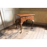 A GEORGE II WALNUT AND FEATHER BANDED SIDE TABLE, CIRCA 1730