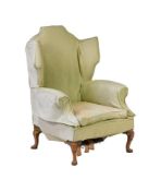 A WALNUT AND UPHOLSTERED WING ARMCHAIRIN GEORGE II STYLE