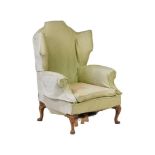 A WALNUT AND UPHOLSTERED WING ARMCHAIRIN GEORGE II STYLE