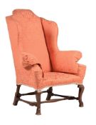 A WALNUT AND UPHOLSTERED WING ARMCHAIR IN WILLIAM & MARY STYLE