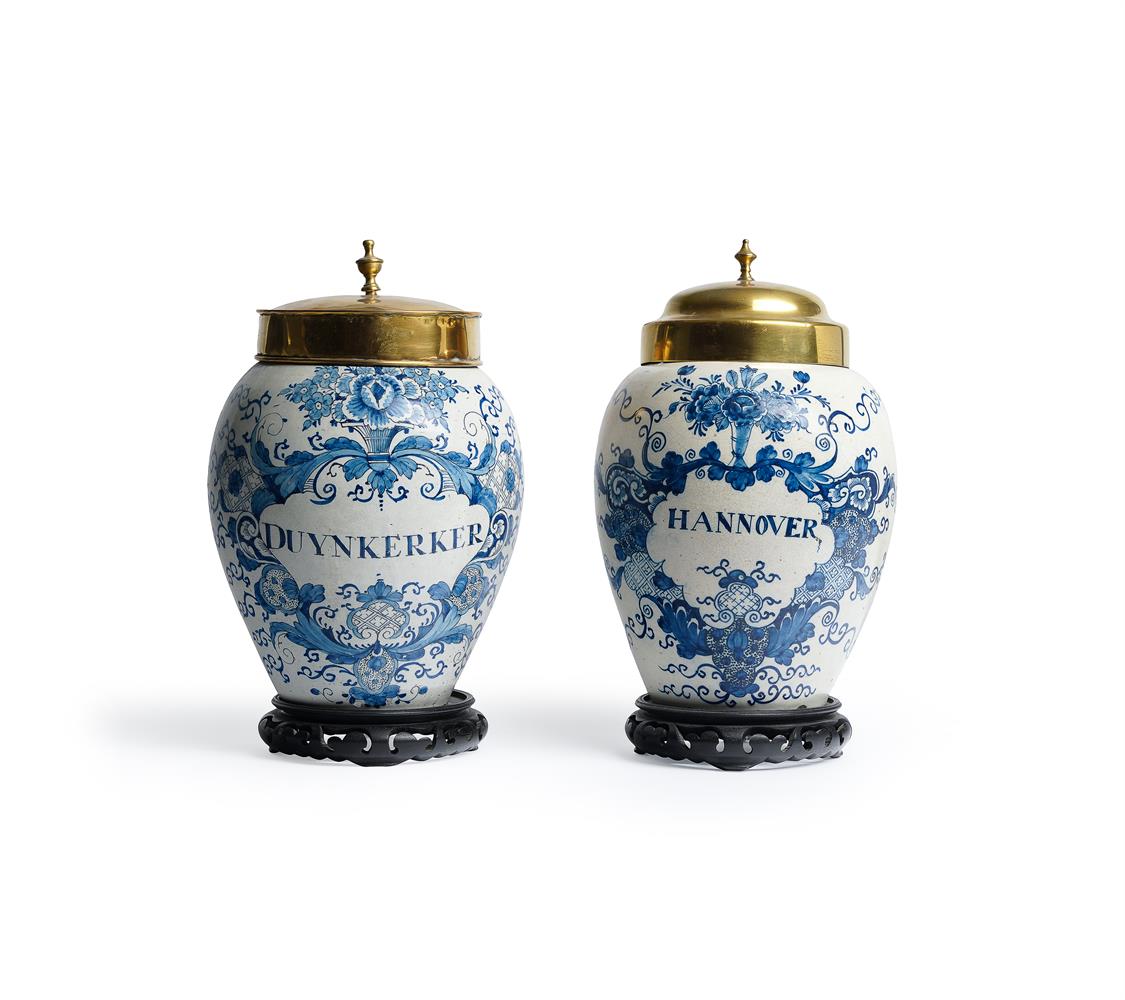 TWO SIMILAR DUTCH DELFT BLUE AND WHITE TOBACCO JARS AND ASSOCIATED BRASS COVERS
