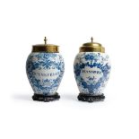 TWO SIMILAR DUTCH DELFT BLUE AND WHITE TOBACCO JARS AND ASSOCIATED BRASS COVERS