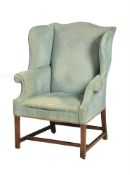 A MAHOGANY AND UPHOLSTERED WING ARMCHAIR
