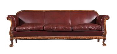A WALNUT AND LEATHER UPHOLSTERED BERGERE SOFA