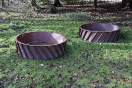 A PAIR OF SUBSTANTIAL CAST IRON AND SHEET METAL LINED CIRCULAR PLANTERS