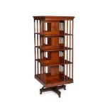 A WALNUT AND ASH REVOLVING BOOKCASE