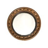 A REGENCY GILTWOOD CONVEX WALL MIRROR