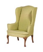 A WALNUT AND UPHOLSTERED WING ARMCHAIR IN GEORGE III STYLE