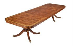 A MAHOGANY AND BRASS INLAID DINING TABLE IN REGENCY STYLE