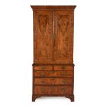 A WALNUT AND FEATHER BANDED CABINET ON CHEST