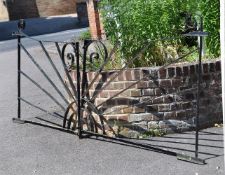A PAIR OF BLACK PAINTED CAST IRON GARDEN GATES IN ART DECO STYLE
