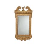 A GILTWOOD WALL MIRROR IN GEORGE II STYLE