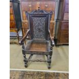 Victorian Wainscott type armchair, back carved with grotesque profile and thistle decoration.