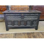 Large late 18th century coffer with heavily carved front panels and simpler 3 panel lid, 54.5"