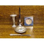 Small silver dish, 2 silver specimen vases, silver picture frame and a silver handled butter knife.