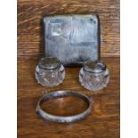 Silver engine turned cigarette case, chased split bangle and a pair of silver topped pots (silver