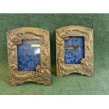 Pair of oriental white metal photograph frames decorated with 3 toe Dragons each 13cm x 9cm.