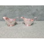 Pair of Mappin & Webb sauce boats with scrolled handles on oval platform base, each 16cm long. Assay