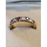 18ct yellow gold ruby and diamond 7 stone half eternity ring in cut setting.