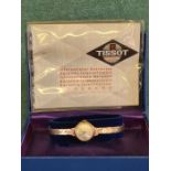 Ladies 9ct gold Tissot watch in working condition with original box and paperwork. 11.2g gold