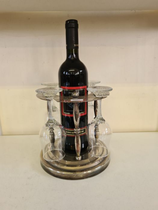A modern EPNS wine bottle and glass stand with turned pillar supports.