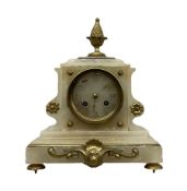 A 19th century French mantle clock in an alabaster case with cast brass mounts and pineapple finial