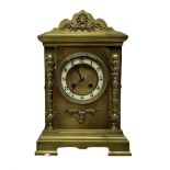 A late 19th century French mantle clock in a brass break-front case with a shaped pediment and corni