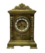 A late 19th century French mantle clock in a brass break-front case with a shaped pediment and corni