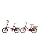 Two vintage red children's bikes