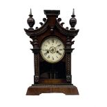 A German 19th century striking mantle clock in a wooden case on a canted plinth