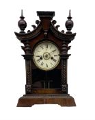 A German 19th century striking mantle clock in a wooden case on a canted plinth