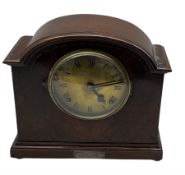 An American early 20thth century eight-day mantle clock in a mahogany case striking the hours and ha