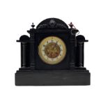 A late 19th century French mantle clock in a Belgium slate case with an arched top and stepped plin
