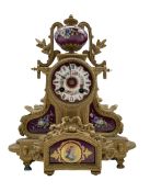 A late-19th century French mantle clock in a gilt spelter case surmounted with a hand painted porcel