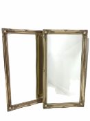 Pair of bevel edged wall mirrors in a swept silver gilt floral moulded frames 75cm x 137cm