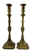 Pair of tall 19th century brass candlesticks with baluster stems and square bases H43cm