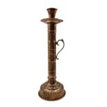 Copper and brass handled candle holder of cylindrical form with engraved decoration on reeded circul