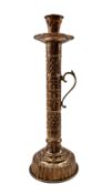 Copper and brass handled candle holder of cylindrical form with engraved decoration on reeded circul