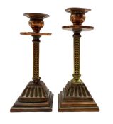 Pair of Arts and Crafts candlesticks with copper drip pans and square section stems on reeded square