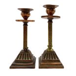 Pair of Arts and Crafts candlesticks with copper drip pans and square section stems on reeded square