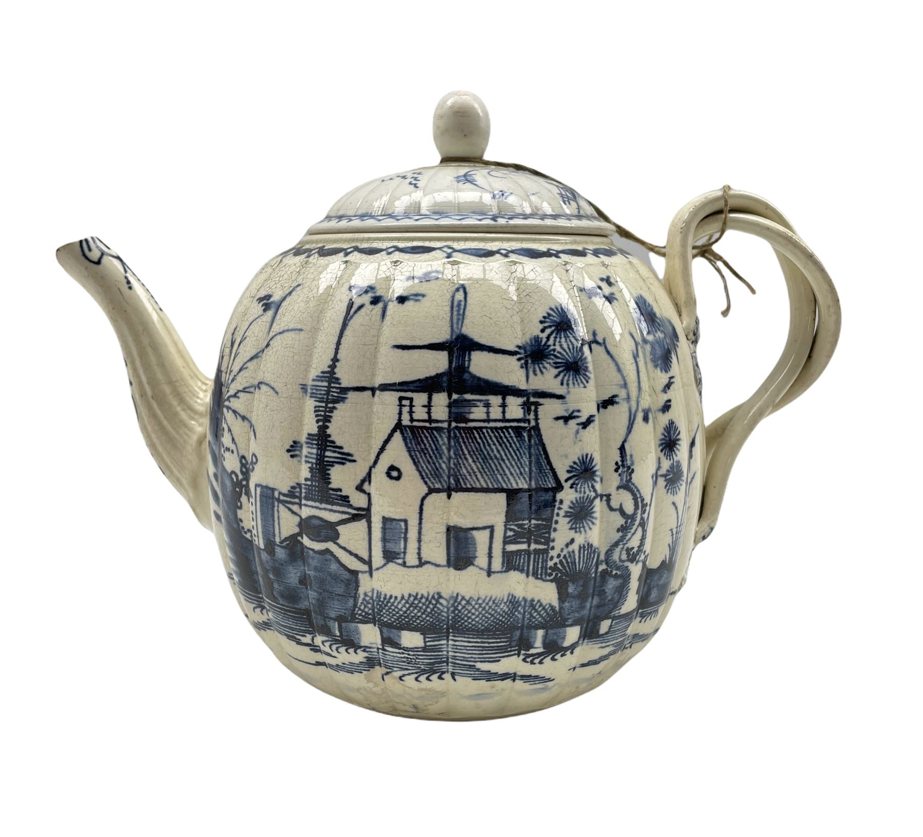 18th century Creamware teapot of melon form with blue chinoiserie design and strapwork handle