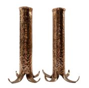 Pair of hammered copper cylindrical vases on splayed supports