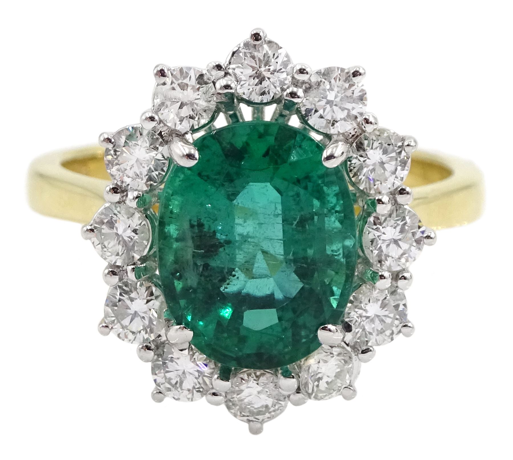 18ct gold oval emerald and round brilliant cut diamond cluster ring