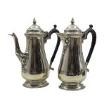 Silver coffee pot and matching hot water jug of baluster design with domed covers and ebonised handl