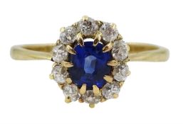 Gold oval synthetic sapphire and diamond cluster ring