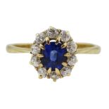 Gold oval synthetic sapphire and diamond cluster ring