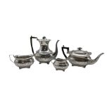 Silver three piece tea set with embossed half body decoration