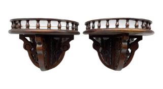 Pair of mahogany demi lune wall brackets with spindle galleries above floral pierced supports
